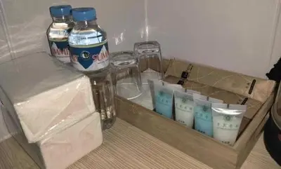 a wooden tray with bottles of water and cups at Venice Star Grand Hotel in Manila