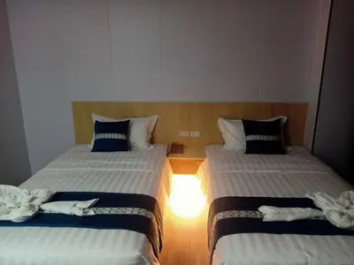 two beds in a hotel room with towels on them at Venice Star Grand Hotel in Manila