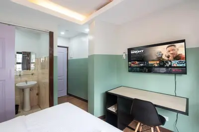 a bedroom with a desk and a tv on the wall at St. Marvin Studio Makati M403 in Manila