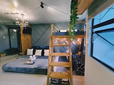 a room with a bunk bed and a ladder at El Nissi Staycation, FAMILY CABIN, CONTEMPORARY CABIN, Enchanted Kingdom in Santa Rosa