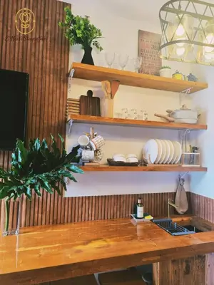 a kitchen with wooden shelves and a wooden table at El Nissi Staycation, FAMILY CABIN, CONTEMPORARY CABIN, Enchanted Kingdom in Santa Rosa