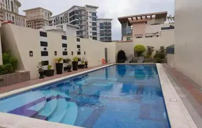 a swimming pool in the middle of a building at Cozy Corner Haven near Venice Grand Canal Mall in Manila