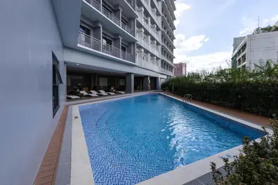 a swimming pool in front of a building at Lush Residences Makati in Manila