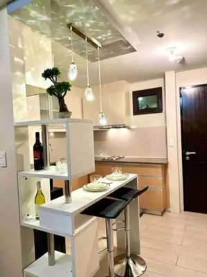 a kitchen with a table with a bottle of wine at Airport NAIA Terminal 3 Insane Interior in Manila