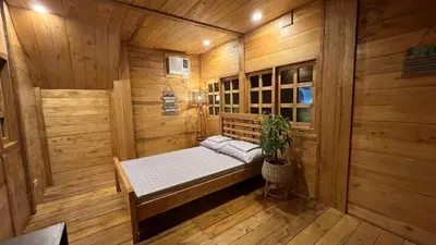 a sauna with a bed in a wooden room at CD NATUREVIEW in Matangtubig