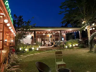a group of people in a backyard at night at CD NATUREVIEW in Matangtubig