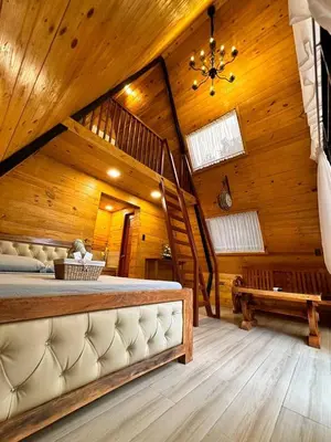 a bedroom with a large bed and a wooden ceiling at CD NATUREVIEW in Matangtubig