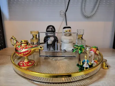 a glass table with figurines and a snowman on it at SHORE 3 TOWER 1 Mall of Asia- Casa Sandique in Manila