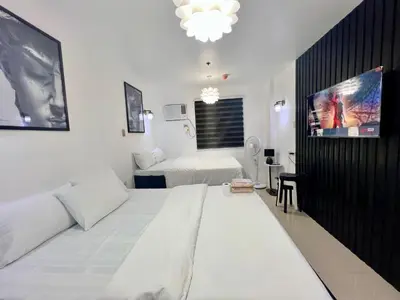 a white room with a bed and a tv at Staycation Condotel Room to Stay Paranaque in Manila
