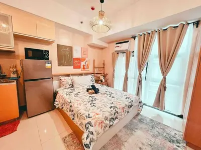 a bedroom with a bed with a teddy bear on it at Condo Unit Viceroy Residences Mckinley Hill cd22b in Manila