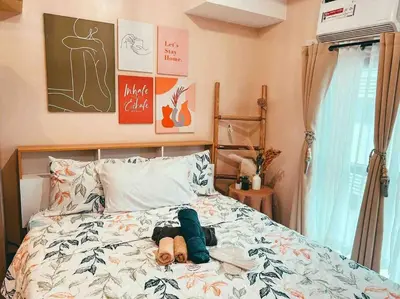 a bed with a doll laying on top of it at Condo Unit Viceroy Residences Mckinley Hill cd22b in Manila