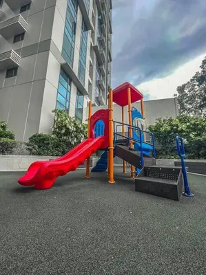 a playground with a slide in front of a building at Condo Unit Viceroy Residences Mckinley Hill cd22b in Manila