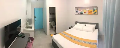 a small bedroom with a bed and a bathroom at COCO STAR HOTEL in Manila