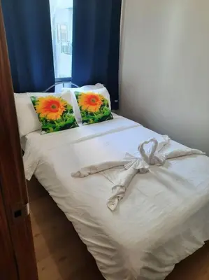 a white bed with flowers on top of it at SMDC Spring Malachai's place in Manila