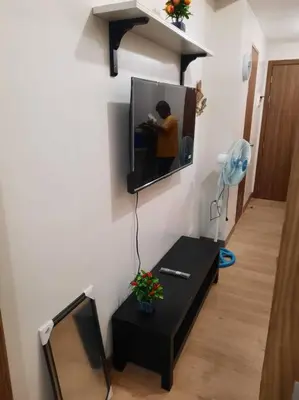 a living room with a tv on a wall at SMDC Spring Malachai's place in Manila