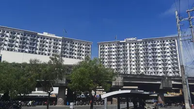 two tall buildings in a city with a street at SMDC Spring Malachai's place in Manila