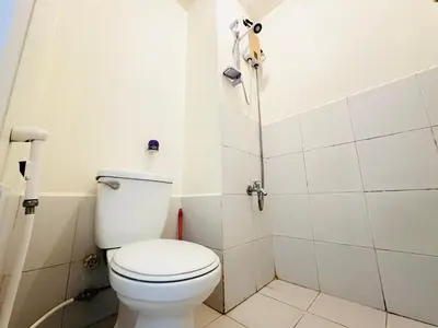 a bathroom with a toilet and a shower at Fancy Condo with Unli Wifi and Netflix in Manila