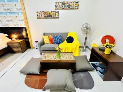 a living room with a couch and a table at MODERN BGC 1BR, Uptown Mall Connector, 5G WiFi, Pool, Ste 17 in Manila