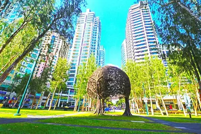 a sculpture in a park in a city with tall buildings at MODERN BGC 1BR, Uptown Mall Connector, 5G WiFi, Pool, Ste 17 in Manila