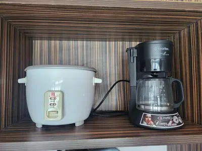a shelf with a coffee maker and a blender on it at KL Tower Cosy Studio with Balcony Sauna Gym Pool near Greenbelt in Manila