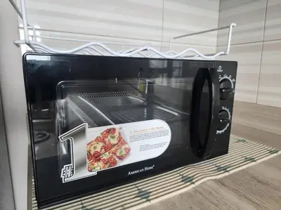a small microwave with a slice of pizza in it at KL Tower Cosy Studio with Balcony Sauna Gym Pool near Greenbelt in Manila