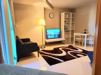 a living room with a television and a couch at BGC Cosy Spacious 1BR Uptown Parksuites with Balcony in Manila