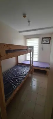 a room with two bunk beds and a window at Arveelene Bedspacing in Manila