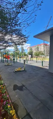 a park with several exercise equipment in a city at Arveelene Bedspacing in Manila
