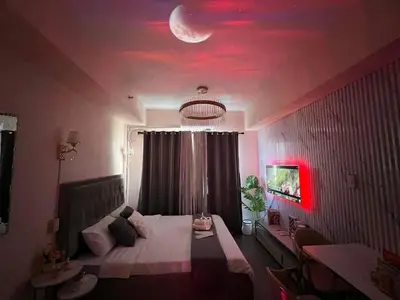 a bedroom with a bed with a moon on the ceiling at Grace Residences Elevate Escapes - near BGC airport in Manila