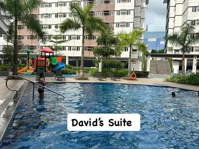 a woman is in a pool with a playground at Davids Suite at Hope Residences Trece Martires Cavite in Trece Martires