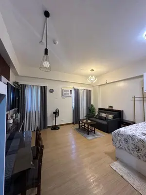 a living room with a bed and a couch at Davids Suite at Hope Residences Trece Martires Cavite in Trece Martires