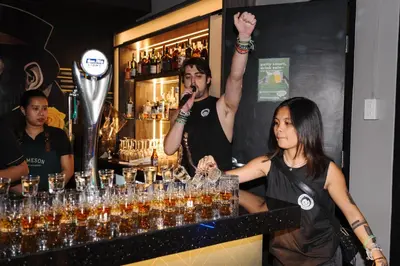 a woman standing in front of a bar with a microphone at Mad Monkey Manila in Manila