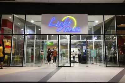 a light mall with people walking outside of it at Ever Stays at Light Residences 1BR in Manila