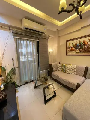 a living room with a couch and a table at Montecito Luxury 1 bedroom condominium in Manila