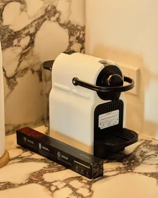 a toaster sitting on a counter next to two books at BGC Suite with Golf Course View in Manila