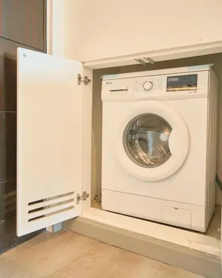 a white washer and dryer in a room at BGC Suite with Golf Course View in Manila