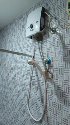 a shower head on a wall in a bathroom at Masterpiece Staycation Makati in Manila
