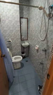 a bathroom with a toilet and a sink at Masterpiece Staycation Makati in Manila