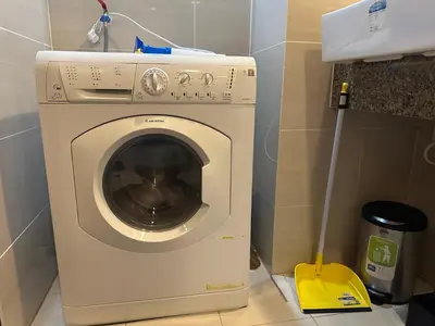 a washing machine in a bathroom with a mop at Deluxe Suite in One Uptown, BGC with Mall Fountain View in Manila