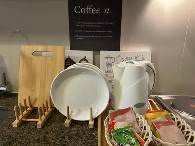 a counter top with a coffee maker and a container at Deluxe Suite in One Uptown, BGC with Mall Fountain View in Manila