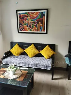 a living room with a couch and a table at Palm Tree Villas - Studio Unit in Manila