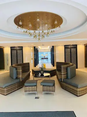 a large living room with couches and a chandelier at Connie's Fame Residence City Haven in Manila