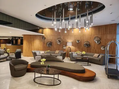 a lobby with couches and tables and a chandelier at Goshen E320 in Manila