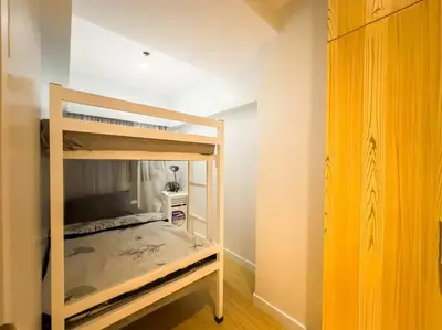 a small bedroom with a bunk bed in a room at A2J Luxury 2BR BGC Suite Near High Street, Malls in Manila