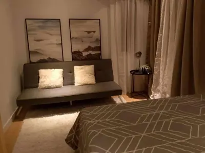 a bedroom with a couch with two pillows at A2J Luxury 2BR BGC Suite Near High Street, Malls in Manila
