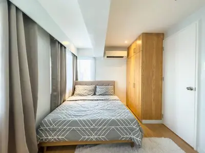 a small bedroom with a bed and a window at A2J Luxury 2BR BGC Suite Near High Street, Malls in Manila
