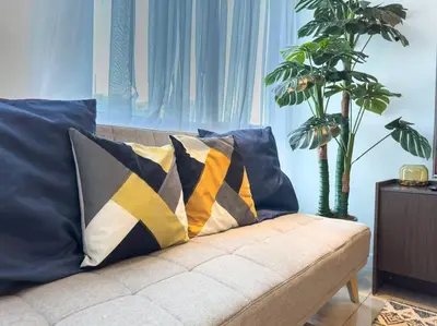 a couch with pillows on it in a living room at A2J Luxury 2BR BGC Suite Near High Street, Malls in Manila