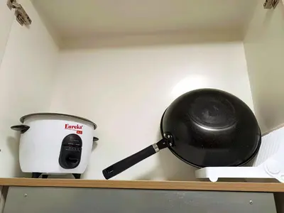 a pan sitting on a shelf next to a slow cooker at Shore 2 Residences T1, MoA WTC SMX Arena 1br 4pax in Manila
