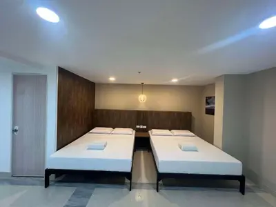 a room with two beds in a room at Maine City Residences Tramo in Manila