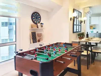 a room with a foosball table and a dartboard at BGC - Two Bedroom Condo with Game Room high speed WiFi in Manila
